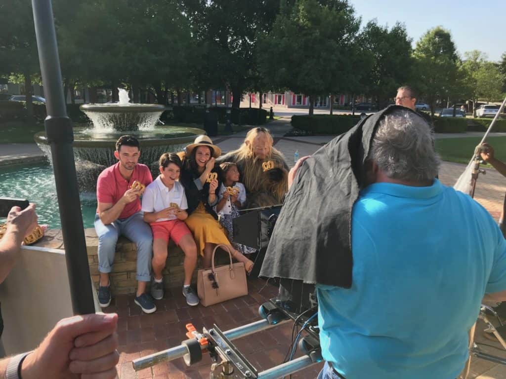 Behind the scenes shot of group in front of fountain filming for dfw airport