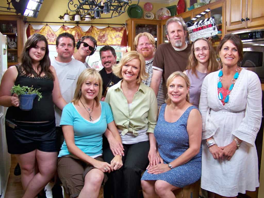Posed photo of group on set at a cooking show