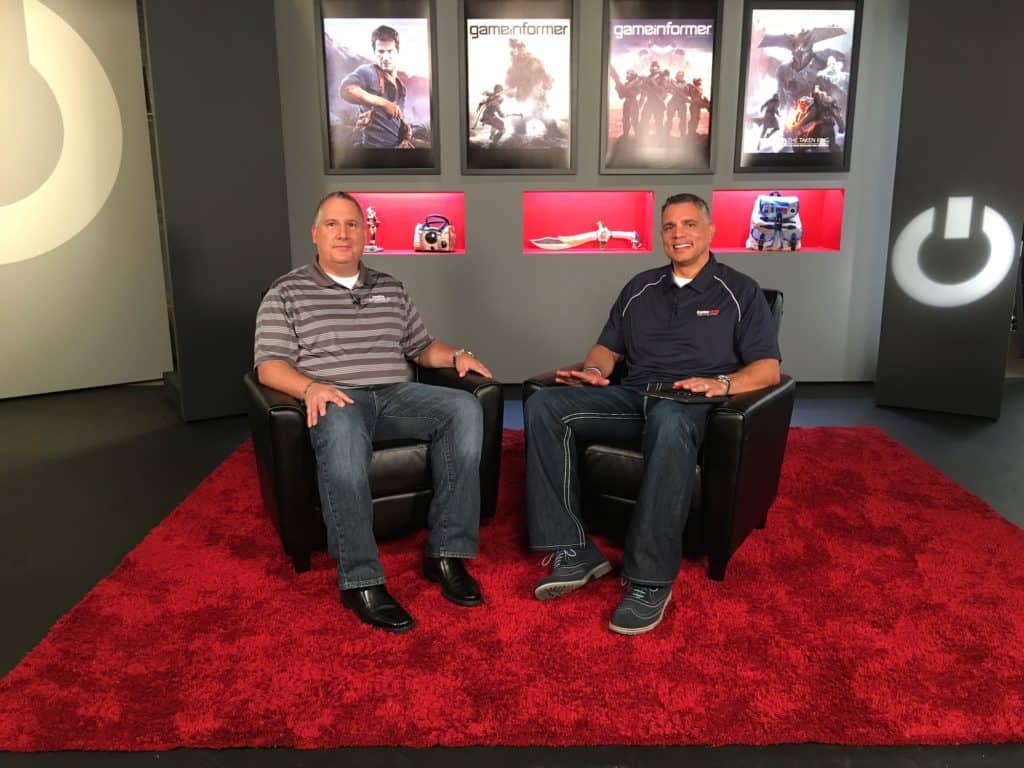 Two men in chairs on Gamestop set